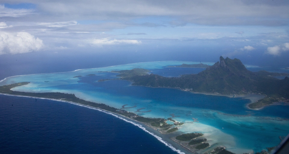 Aerial view of the Bora Bora lagoon's sandbars and reef patterns crossed on the Rohivai full day lagoon safari, French Polynesia
